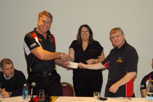 John Bastian receives cheque from BullBuilder