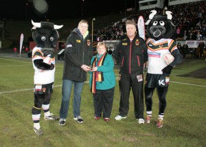 Liam Kirk receives March Player of the Month award from BullBuilder Board member, Jen Bennison